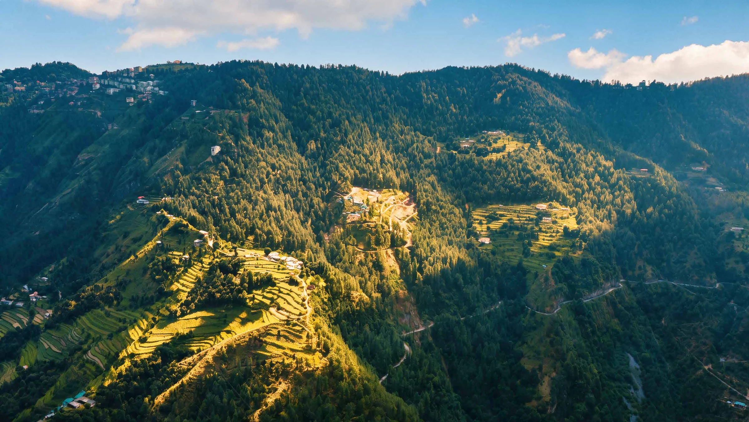 Abhinandan Lodha Shimla - The Ridge Mashobra hillside and terraced slopes in golden evening light